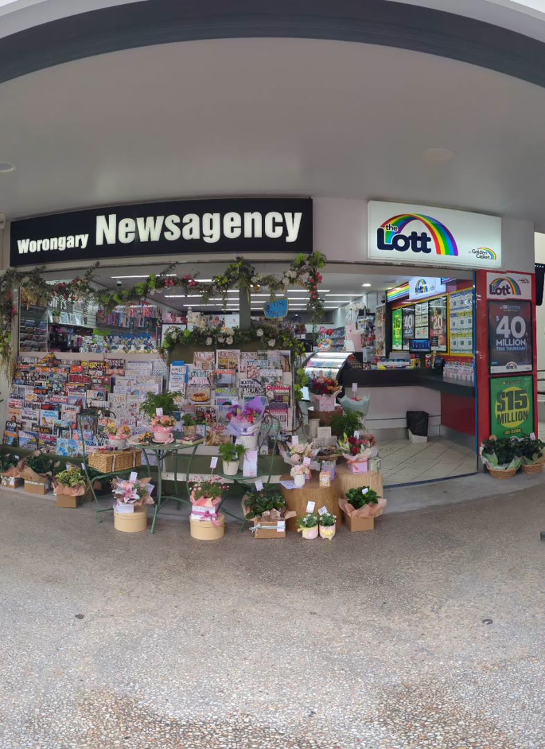 Outside Worongary News, with flowers and newspapers at the front of the shop